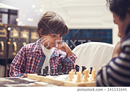 Child, father and chess game with thinking strategy or checkmate move with knight, king or queen. Son, parent and board for competition learn or decision thoughts for play, contest or problem solving Child, father and chess game with thinking strategy or checkmate move with knight, king or queen. Son, parent and board for competition learn or decision thoughts for play, contest or problem solving 141131045