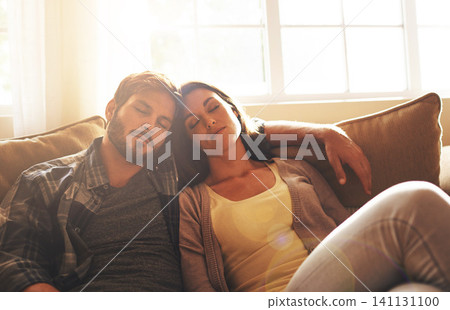 Sleeping, tired and couple on sofa to relax with sunshine for resting, comfortable and dreaming in home. Marriage, dating and man and woman on couch together for cuddle, nap and asleep in living room Sleeping, tired and couple on sofa to relax with sunshine for resting, comfortable and dreaming in home. Marriage, dating and man and woman on couch together for cuddle, nap and asleep in living room 141131100