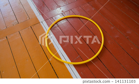Gymnastics hoop. Physical education. Fitness, Dieting, healthy lifestyle Concept, Sport Item exercise accessories. Lockers in gym locker room background. Copy space. Indoor workout. Wellness exercise. Gymnastics hoop. Physical education. Fitness, Dieting, healthy lifestyle Concept, Sport Item exercise accessories. Lockers in gym locker room background. Copy space. Indoor workout. Wellness exercise. 141131103