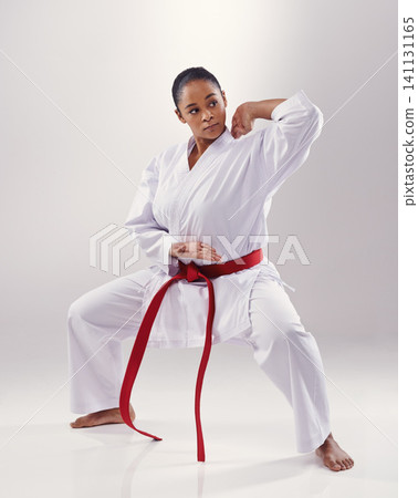 Woman, training and karate fighter in studio, fitness and martial arts on white background. Black person, athlete and red belt for taekwondo, discipline and warrior ready for self defense or battle Woman, training and karate fighter in studio, fitness and martial arts on white background. Black person, athlete and red belt for taekwondo, discipline and warrior ready for self defense or battle 141131165