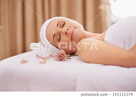 Woman, spa and rest for zen, wellness and peace with relaxation and calm. Lady, towel and massage table at resort, lounge or luxury parlor with rose for holistic body and skincare for detox and break Woman, spa and rest for zen, wellness and peace with relaxation and calm. Lady, towel and massage table at resort, lounge or luxury parlor with rose for holistic body and skincare for detox and break 141131174