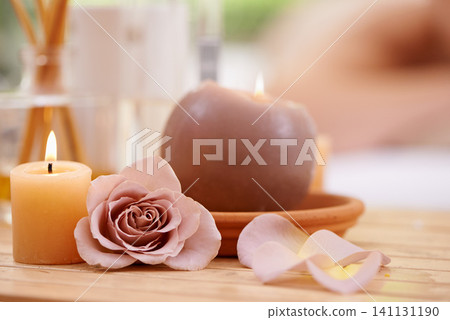 Closeup of candles, rose and holistic healing at spa for aromatherapy, wellness and treatment for self care. Detox, stress relief and energy balance for aura with tools, luxury and natural with zen Closeup of candles, rose and holistic healing at spa for aromatherapy, wellness and treatment for self care. Detox, stress relief and energy balance for aura with tools, luxury and natural with zen 141131190