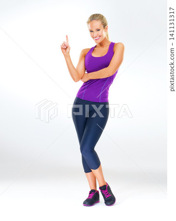 Woman, portrait and workout clothes in studio with finger for routine as strong athlete, lose weight or white background. Female person, face and confidence for fitness performance, pilates or mockup Woman, portrait and workout clothes in studio with finger for routine as strong athlete, lose weight or white background. Female person, face and confidence for fitness performance, pilates or mockup 141131317
