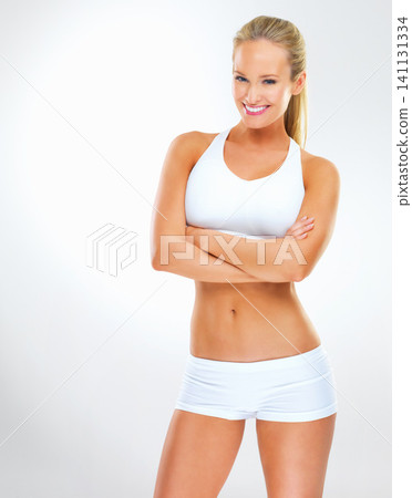 Portrait, fitness and happy woman with arms crossed for body or exercise in studio isolated on a white background. Confidence, sport or healthy person in workout or training on mockup space in Sweden Portrait, fitness and happy woman with arms crossed for body or exercise in studio isolated on a white background. Confidence, sport or healthy person in workout or training on mockup space in Sweden 141131334