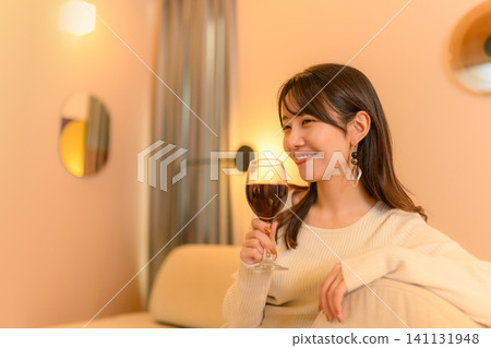 A woman enjoying wine 141131948
