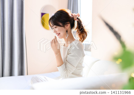A woman tying her hair A woman tying her hair 141131966