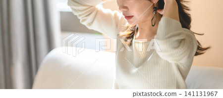 A woman preparing her hair A woman preparing her hair 141131967