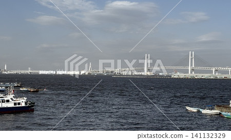 The Yokohama Bay Bridge and the sea view spanning Yokohama Port under a blue sky. The Yokohama Bay Bridge and the sea view spanning Yokohama Port under a blue sky. 141132329
