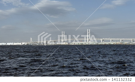 The Yokohama Bay Bridge spanning Yokohama Port and the harbor scenery against a clear blue sky. The Yokohama Bay Bridge spanning Yokohama Port and the harbor scenery against a clear blue sky. 141132332
