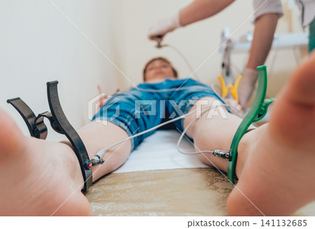 Doctor with electrocardiogram equipment making cardiogram test Doctor with electrocardiogram equipment making cardiogram test 141132685