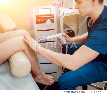 Magnet therapy system. Patient with doctor in office. Magnet therapy system. Patient with doctor in office. 141132710