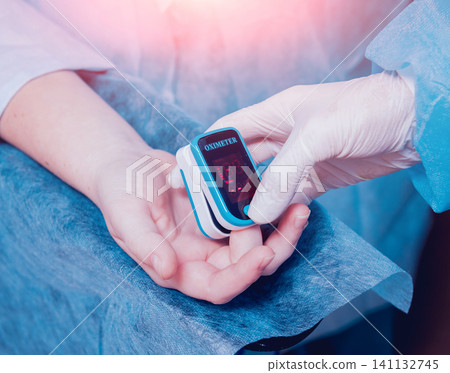 Pulse oximeter on the patient's hand 141132745