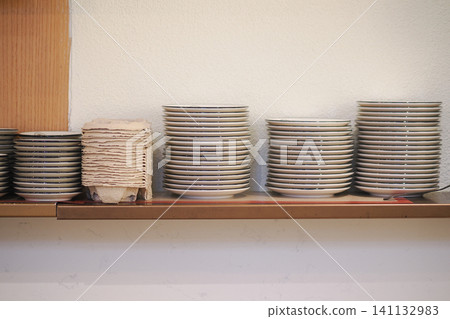 Stacks of beautifully organized dishes in a cozy kitchen Stacks of beautifully organized dishes in a cozy kitchen 141132983