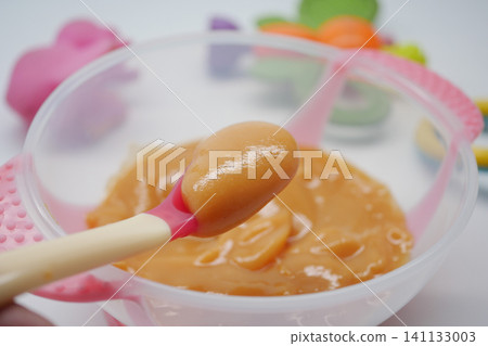 Sweet and smooth baby food preparation in a colorful kitchen Sweet and smooth baby food preparation in a colorful kitchen 141133003
