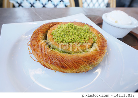 Burma Kadayif, a Turkish pastry made of shredded dough, honey, and pistachios. Burma Kadayif, a Turkish pastry made of shredded dough, honey, and pistachios. 141133032
