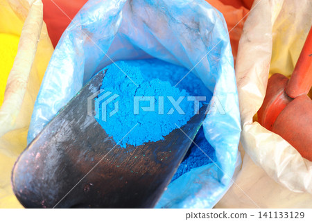 Vibrant blue powder shines in colorful art supplies Vibrant blue powder shines in colorful art supplies 141133129