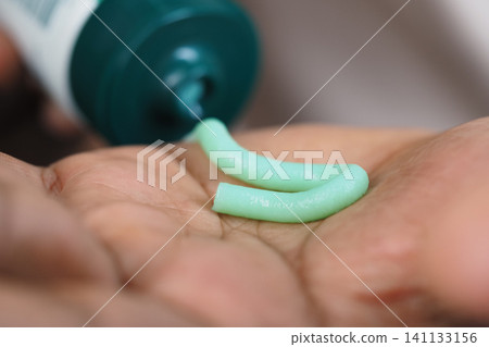 creamy substance being squeezed from a tube, closely resembling Aloe Vera Scrub creamy substance being squeezed from a tube, closely resembling Aloe Vera Scrub 141133156