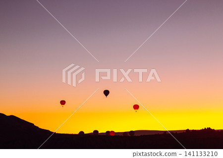 Open Air Museum. Flying hot air balloons rise in sunrise Cappadocia. Goreme National Park Turkey. Open Air Museum. Flying hot air balloons rise in sunrise Cappadocia. Goreme National Park Turkey. 141133210