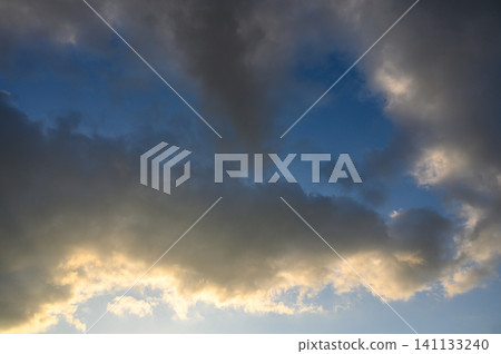 Dramatic sky with combination of dark dense clouds and bright breaks lighting creating contrast Dramatic sky with combination of dark dense clouds and bright breaks lighting creating contrast 141133240