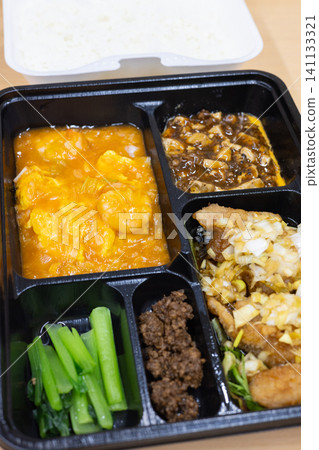 美味的中式便當盒,內含炸雞和辣椒蝦 美味的中式便當盒,內含炸雞和辣椒蝦 141133321