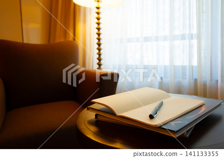 A notebook and pen are placed on the table. A private room with a sofa. A notebook and pen are placed on the table. A private room with a sofa. 141133355