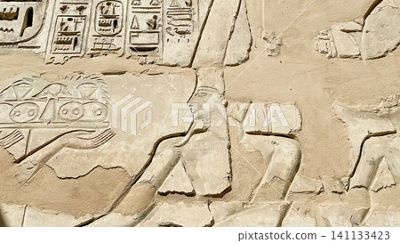 Beautiful bas-reliefs and ancient hieroglyphs from the mortuary temple of Ramesses III at Medinet Habu, Luxor, Egypt. Beautiful bas-reliefs and ancient hieroglyphs from the mortuary temple of Ramesses III at Medinet Habu, Luxor, Egypt. 141133423