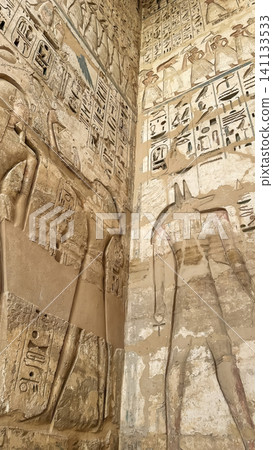 Beautiful bas-reliefs and ancient hieroglyphs from the mortuary temple of Ramesses III at Medinet Habu, Luxor, Egypt. 141133533