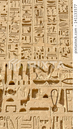 Beautiful bas-reliefs and ancient hieroglyphs from the mortuary temple of Ramesses III at Medinet Habu, Luxor, Egypt. 141133577