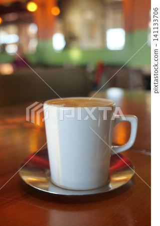 Coffee cup on a table in a cafe during the day Coffee cup on a table in a cafe during the day 141133706