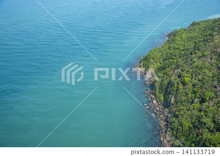 Aerial view of the beautiful coastline with crystal clear emerald sea and lush tropical forest in Phu Quoc Island, Vietnam. Aerial view of the beautiful coastline with crystal clear emerald sea and lush tropical forest in Phu Quoc Island, Vietnam. 141133719