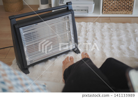Warm feet near a heater on a winter day at home Warm feet near a heater on a winter day at home 141133989