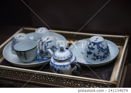 Tray with a teapot, cups, and saucers Tray with a teapot, cups, and saucers 141134074