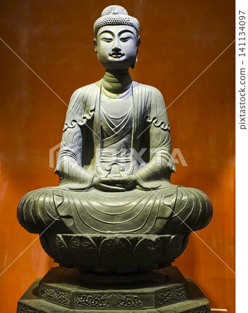 A statue of a person sitting on a lotus flower A statue of a person sitting on a lotus flower 141134097