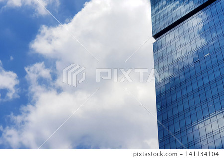 A tall building with a cloudy sky in the background 141134104