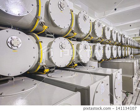 A row of white tanks with yellow caps A row of white tanks with yellow caps 141134107
