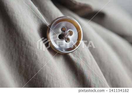 Close up of a button on a piece of clothing Close up of a button on a piece of clothing 141134182