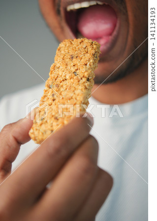 Enjoying a nutritious snack bar in a casual setting Enjoying a nutritious snack bar in a casual setting 141134193