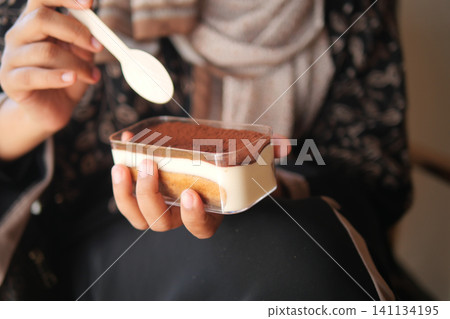 Enjoying a delicious dessert in a cozy setting Enjoying a delicious dessert in a cozy setting 141134195