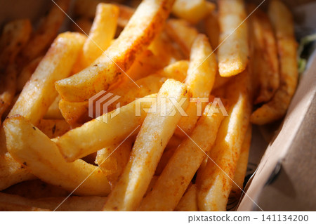 Crispy golden fries served in a fast food container Crispy golden fries served in a fast food container 141134200