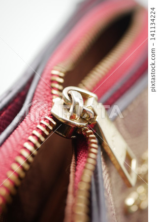 Close view of a broken zipper on a bag Close view of a broken zipper on a bag 141134224