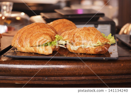 Fresh croissants with lettuce served at a bakery Fresh croissants with lettuce served at a bakery 141134240