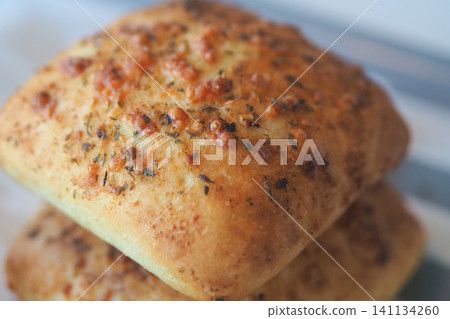 Freshly baked savory bread with herbs and cheese Freshly baked savory bread with herbs and cheese 141134260