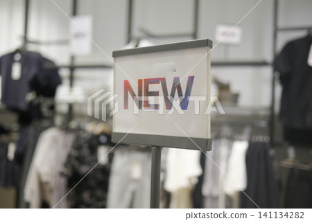 New arrivals displayed in a trendy clothing store section 141134282