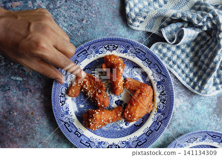 Delicious chicken wings served on a decorative plate 141134309