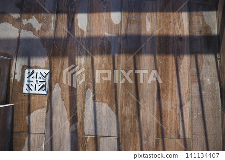 Wet wooden floor with shadows on a sunny day Wet wooden floor with shadows on a sunny day 141134407