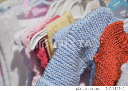 Colorful handmade textiles hang in a boutique Colorful handmade textiles hang in a boutique 141134641