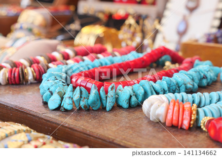 Colorful handmade jewelry on display at a market stall 141134662