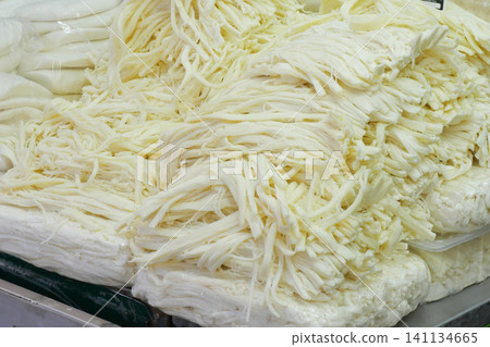 Freshly prepared cheese strands at a market stall in summer Freshly prepared cheese strands at a market stall in summer 141134665