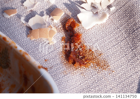 Stains of sauce and egg shells on fabric surface 141134750