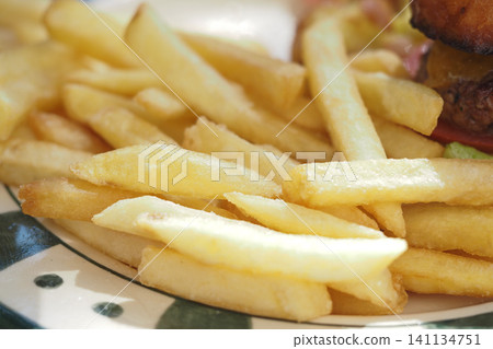 Golden french fries served on a plate with garnishes 141134751
